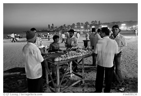 Stall broiling corn at night, Chowpatty Beach. Mumbai, Maharashtra, India