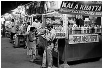 Drinks stall at night, Chowpatty Beach. Mumbai, Maharashtra, India (black and white)