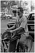 Man sharpening knifes on the street, Colaba. Mumbai, Maharashtra, India ( black and white)