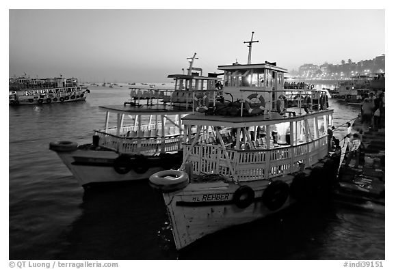 Lighted tour boat at quay,  sunset. Mumbai, Maharashtra, India