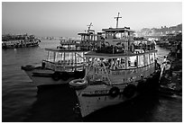 Lighted tour boat at quay,  sunset. Mumbai, Maharashtra, India (black and white)