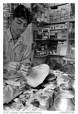 Street vendor preparing a snack with leaves. Mumbai, Maharashtra, India (black and white)