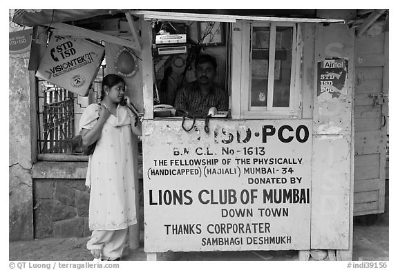 Woman at a street telephone booth. Mumbai, Maharashtra, India