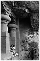 Women sitting at entrance of cave, Elephanta Island. Mumbai, Maharashtra, India (black and white)