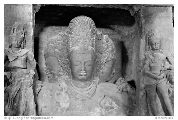 Trimurti flanked by pilasters with figures of dwarplalas, Elephanta caves. Mumbai, Maharashtra, India (black and white)