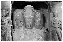 Trimurti flanked by pilasters with figures of dwarplalas, Elephanta caves. Mumbai, Maharashtra, India (black and white)