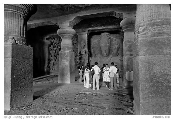 Vistors in main cave, Elephanta Island. Mumbai, Maharashtra, India (black and white)