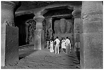 Vistors in main cave, Elephanta Island. Mumbai, Maharashtra, India (black and white)