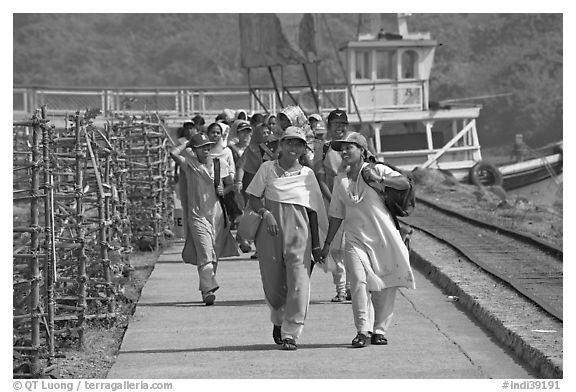 Women walking on  jetty, Elephanta Island. Mumbai, Maharashtra, India (black and white)