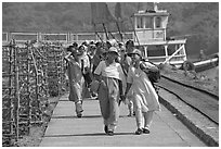 Women walking on  jetty, Elephanta Island. Mumbai, Maharashtra, India (black and white)