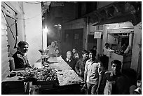 Street with vendor of sweets by night, Taj Ganj. Agra, Uttar Pradesh, India (black and white)