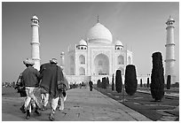 Men walking toward Taj Mahal, early morning. Agra, Uttar Pradesh, India (black and white)