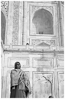 Woman standing at the base of Taj Mahal. Agra, Uttar Pradesh, India (black and white)