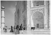 Base of Taj Mahal, minaret, and tourists. Agra, Uttar Pradesh, India (black and white)