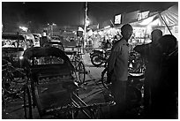 Cycle-rickshaws and vending booths at night, Agra cantonment. Agra, Uttar Pradesh, India (black and white)