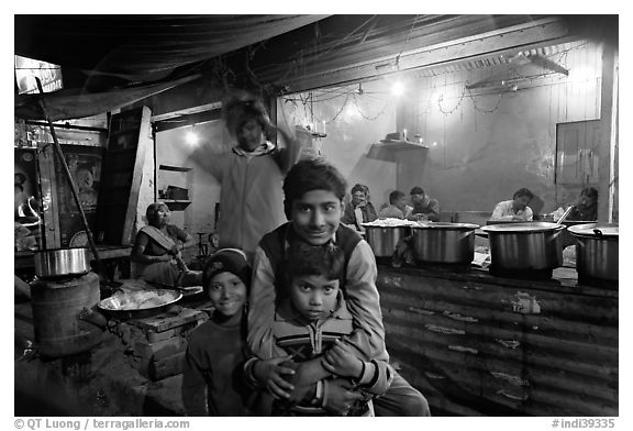 Children and food booth at night, Agra cantonment. Agra, Uttar Pradesh, India (black and white)