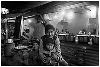 Children and food booth at night, Agra cantonment. Agra, Uttar Pradesh, India (black and white)