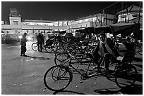 Cycle-rickshaws in front of train station. Agra, Uttar Pradesh, India (black and white)
