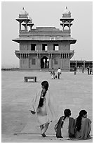 Women, Pachisi courtyard, and Diwan-i-Khas. Fatehpur Sikri, Uttar Pradesh, India (black and white)