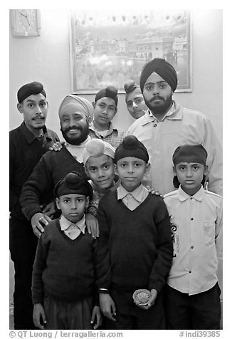 Sikh men and boys in front of picture of the Golden Temple. Bharatpur, Rajasthan, India (black and white)