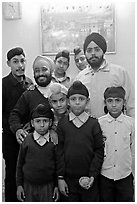 Sikh men and boys in front of picture of the Golden Temple. Bharatpur, Rajasthan, India (black and white)