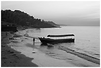 Narrow boat on beach at dawn, Dona Paula. Goa, India (black and white)