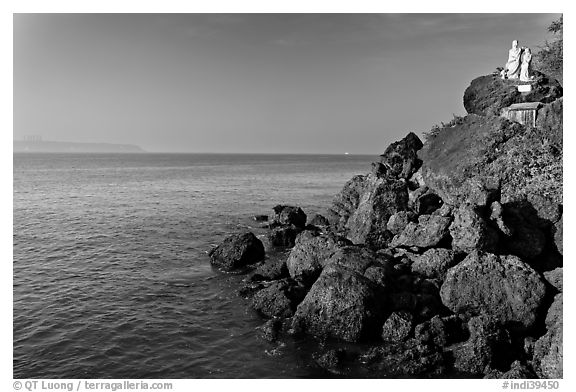 Boulders and christian statues at the edge of ocean, Dona Paula. Goa, India