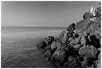 Boulders and christian statues at the edge of ocean, Dona Paula. Goa, India (black and white)