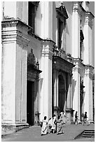 People at the entrance of Se Cathedral, Old Goa. Goa, India (black and white)