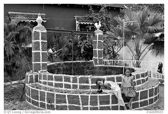 Woman and girls at communal well, Panjim. Goa, India