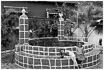 Woman and girls at communal well, Panjim. Goa, India (black and white)