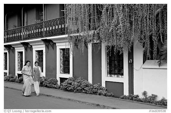 Women strolling past the heritage Panaji Inn, Panjim. Goa, India (black and white)