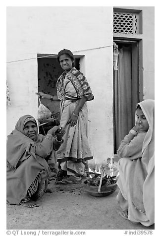 Women cooking outside in village. Khajuraho, Madhya Pradesh, India (black and white)