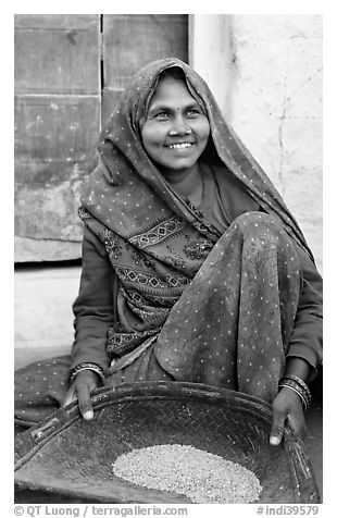 Woman sorting grains. Khajuraho, Madhya Pradesh, India