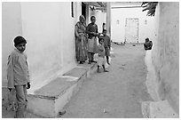Family in village alley. Khajuraho, Madhya Pradesh, India (black and white)