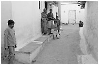 Family in village alley. Khajuraho, Madhya Pradesh, India ( black and white)