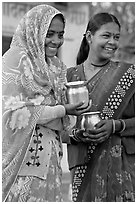 Women with pots used for religious offerings. Khajuraho, Madhya Pradesh, India (black and white)