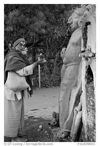 Holy man worshiping Shiva image. Khajuraho, Madhya Pradesh, India (black and white)