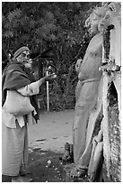 Holy man worshiping Shiva image. Khajuraho, Madhya Pradesh, India (black and white)