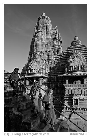 Women going down stairs in front of Lakshmana temple. Khajuraho, Madhya Pradesh, India (black and white)