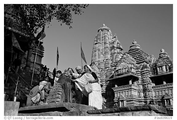 Worshippers making offering at Matangesvara temple with  Lakshmana behind. Khajuraho, Madhya Pradesh, India