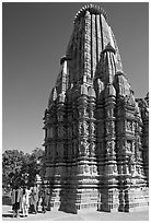 Women walking at the base of the sikhara of Devi Jagadamba temple. Khajuraho, Madhya Pradesh, India (black and white)