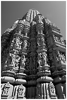 Sculptures and sikhara of Devi Jagadamba temple from below. Khajuraho, Madhya Pradesh, India (black and white)