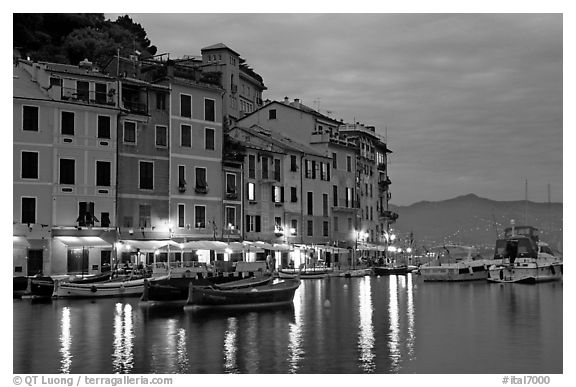 Houses reflected in harbor at dusk, Portofino. Liguria, Italy