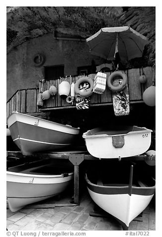 Tiny fishing boats stacked in the main square, Riomaggiore. Cinque Terre, Liguria, Italy (black and white)