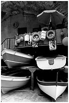 Tiny fishing boats stacked in the main square, Riomaggiore. Cinque Terre, Liguria, Italy ( black and white)