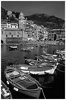 Colorful samll fishing boats in the harbor and main plaza, Vernazza. Cinque Terre, Liguria, Italy ( black and white)