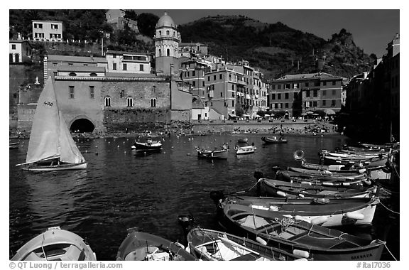 Colorful fishing boats in the harbor and Piazza Guglielmo Marconi, Vernazza. Cinque Terre, Liguria, Italy (black and white)