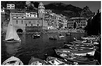 Colorful fishing boats in the harbor and Piazza Guglielmo Marconi, Vernazza. Cinque Terre, Liguria, Italy (black and white)