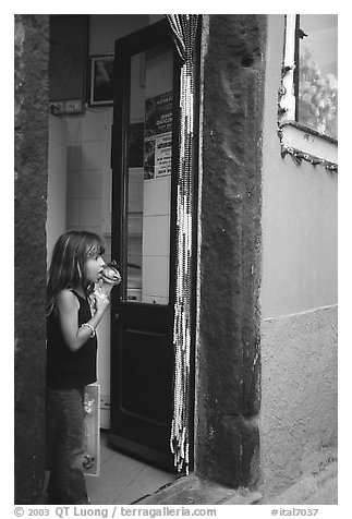 Girl enjoying gelato (ice-cream), Vernazza. Cinque Terre, Liguria, Italy (black and white)